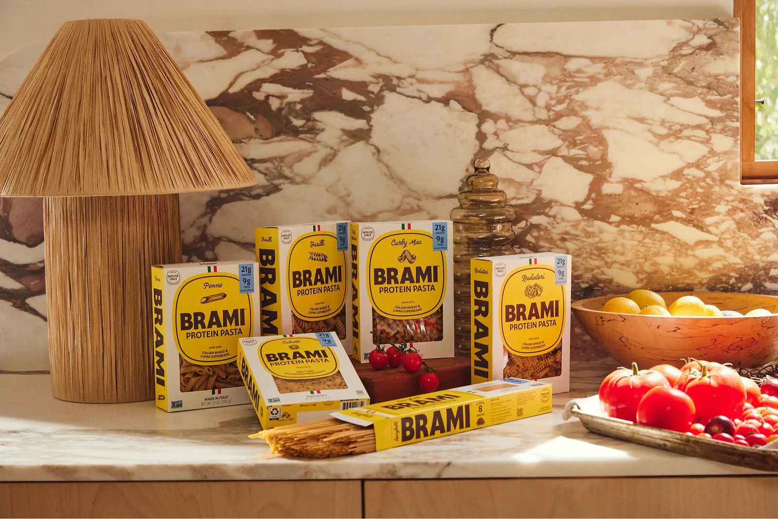 Brami protein pasta boxes styled on a marble kitchen counter